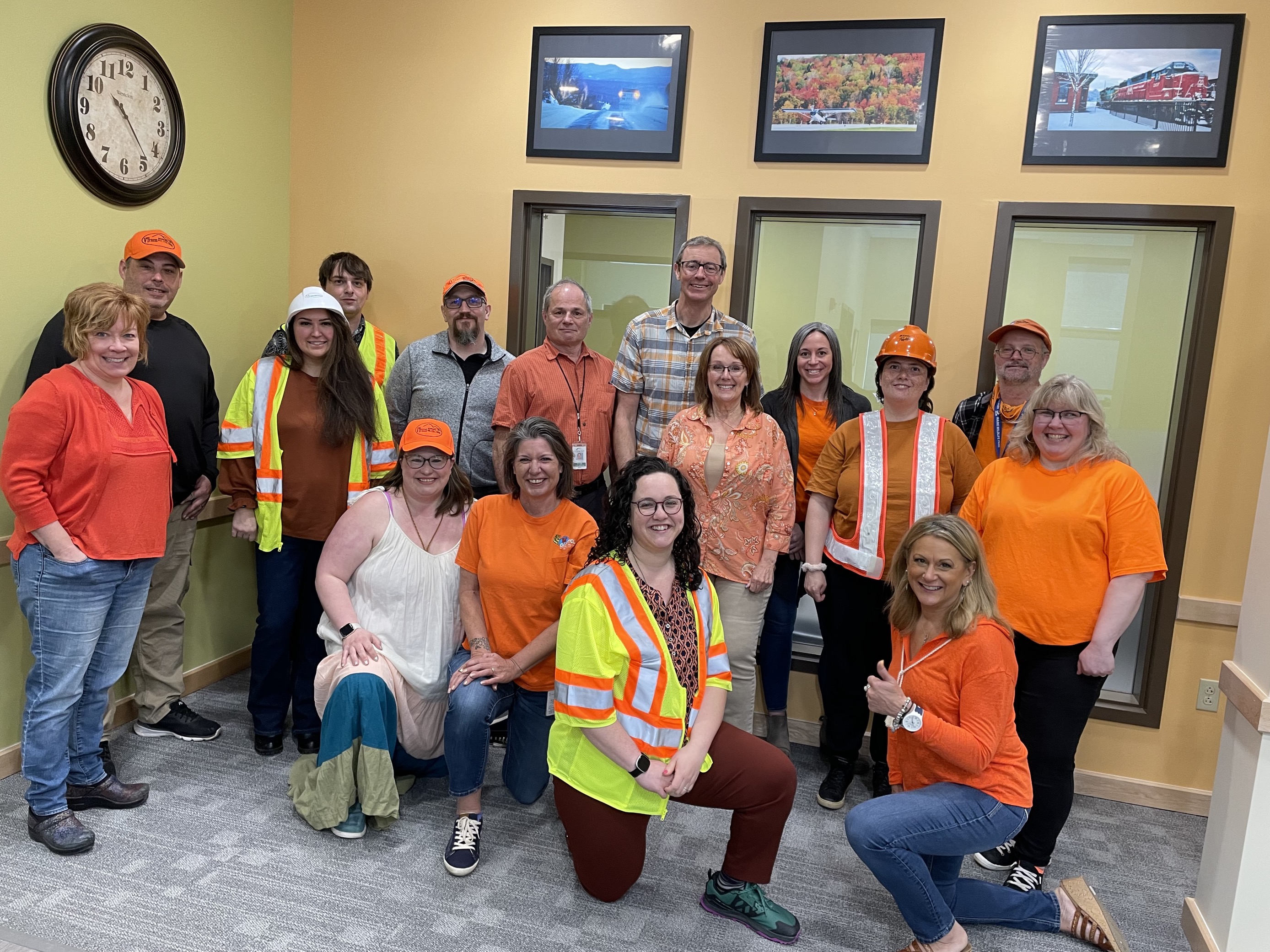 BuILD Team posing for a photo in orange clothing.